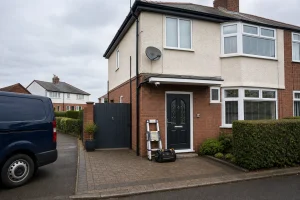 Professional home CCTV camera installed on a UK house with aerial and satellite equipment visible.