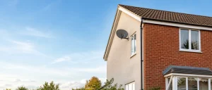 Satellite dish on a house with a clear view of the sky